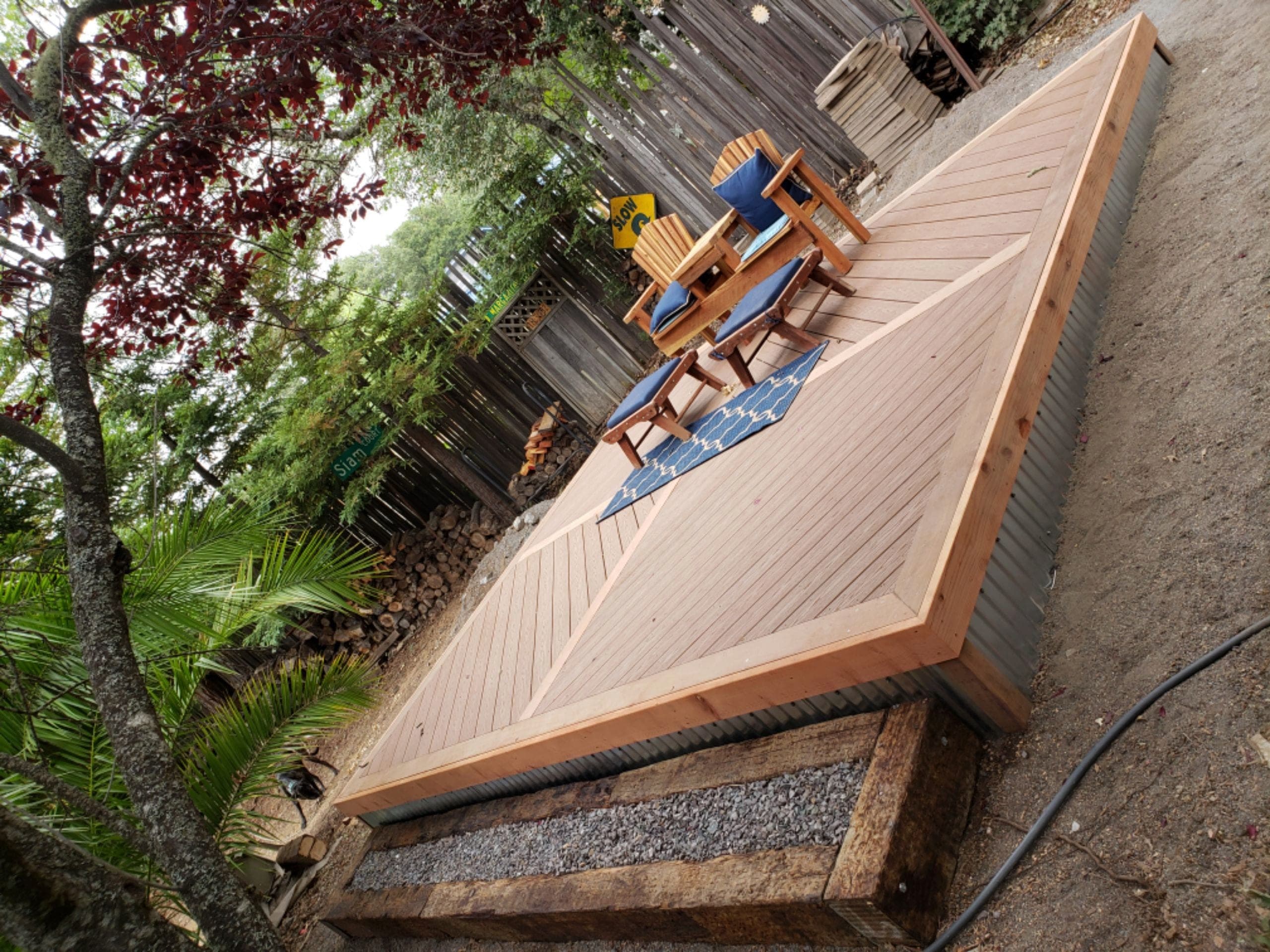 Custom redwood platform deck with a chevron decking pattern and mitered border, built by RLS Custom Carpentry in Mendocino County, CA